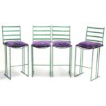 A set of four green painted wrought-iron bar stools.