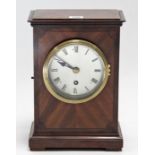 An early 20th century mantel timepiece with black roman numerals to the silvered dial, & in mahogany