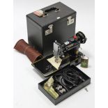 A Singer electric sewing machine (model 221k), w.o., with case.