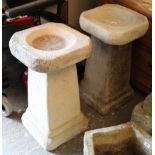 A pair of reconstituted stone garden bird baths each on square tapered centre column & square