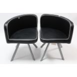 A pair of black & white vinyl triangular-shaped occasional chairs each on four silvered-metal