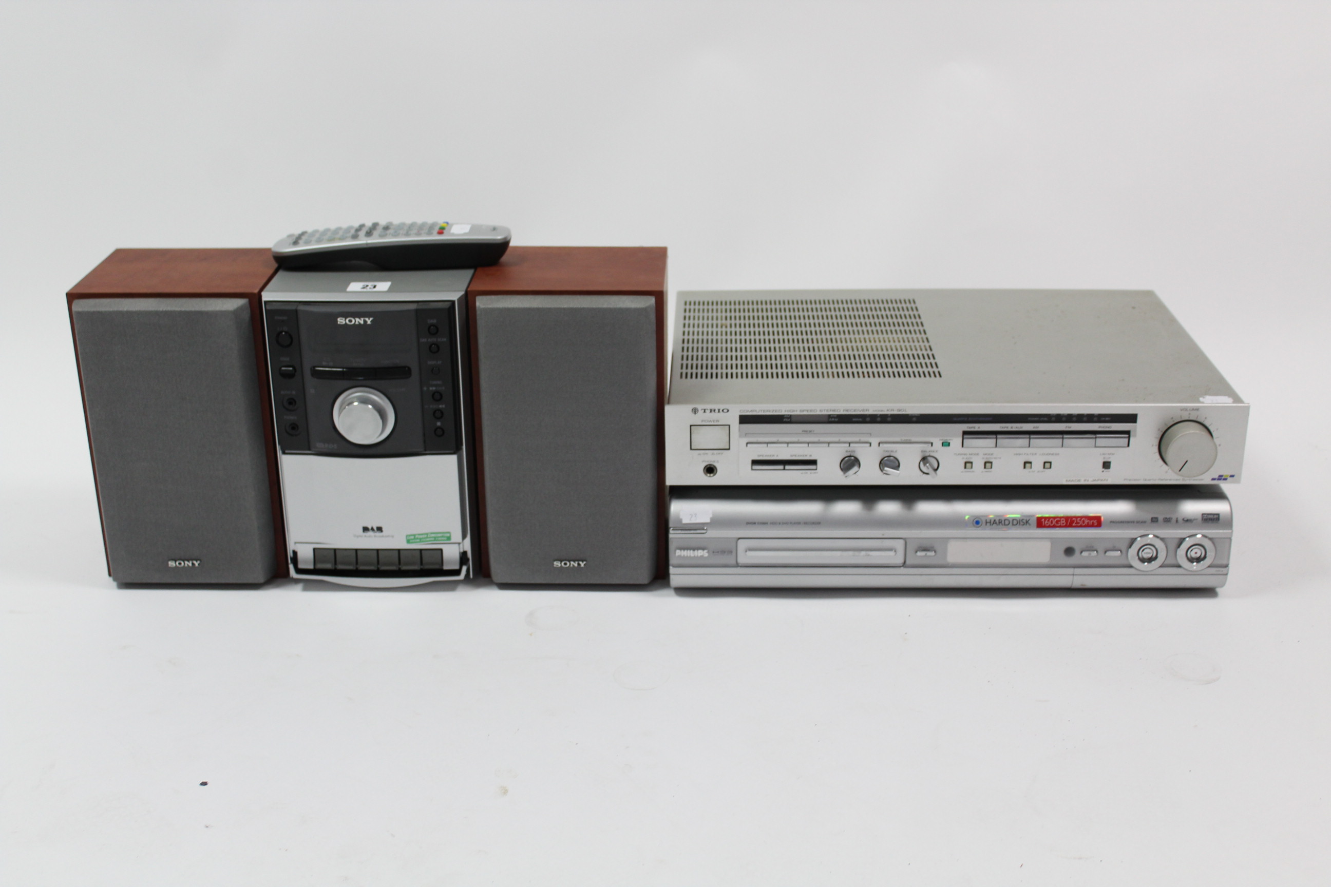 A Sony micro hi-fi system; a Phillips HDD & DVD player, each with remote control; & a Trio stereo