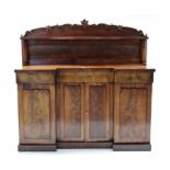 A Victorian mahogany inverted break-front chiffonier with shaped open shelf to the stage back,