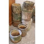 Eight reconstituted-stone rustic-style garden flower pots (various sizes).