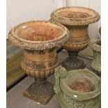 A pair of terracotta garden flower pots of ovoid form, with raised geometrical design, & on square