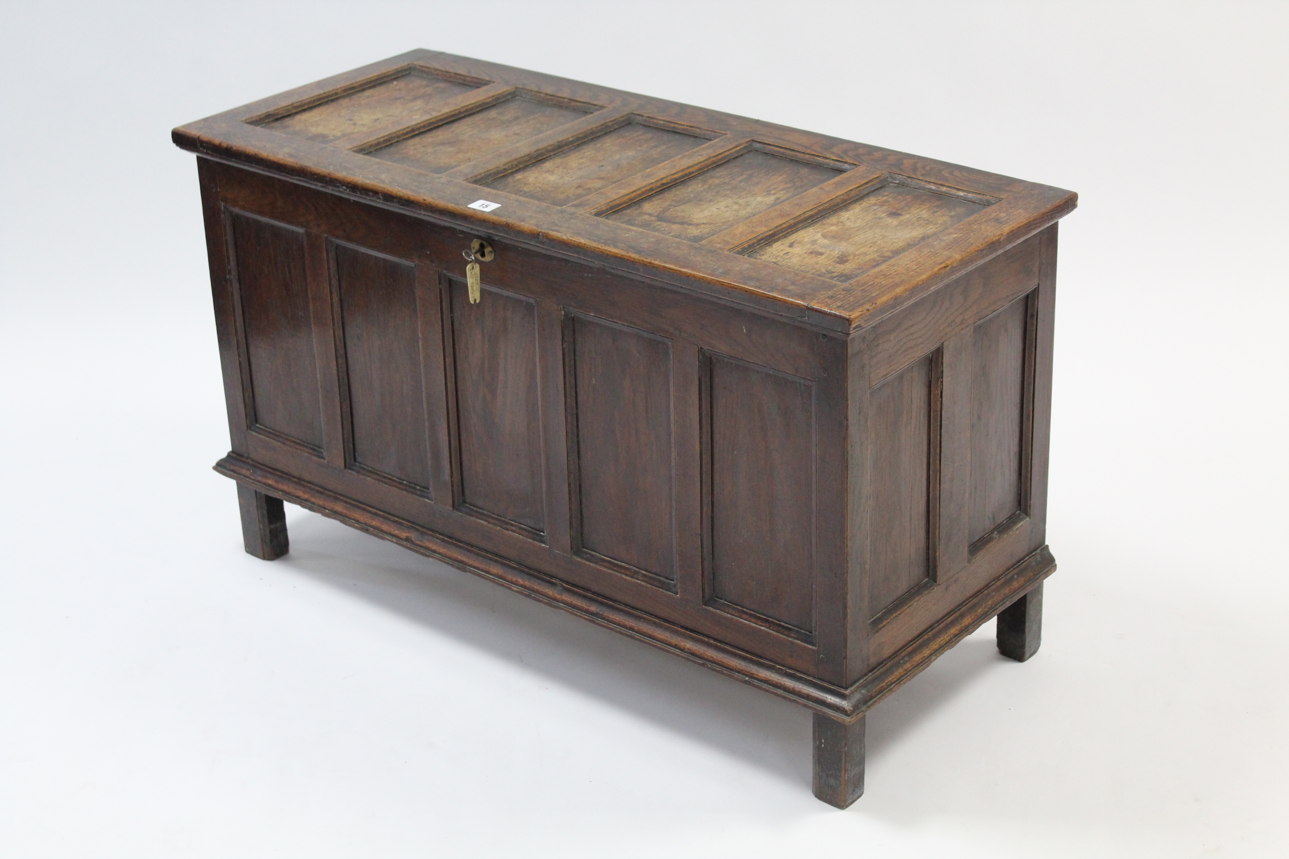 A late 19th/early 20th century small oak coffer with hinged lift-lid, with panelled front & sides, &