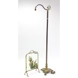 A Victorian style brass scroll-arm standard lamp on triform base; & a brass frame fire screen