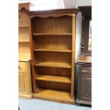 A pine tall standing open bookcase fitted four open shelves & on plinth base 39½” wide x 72” high.