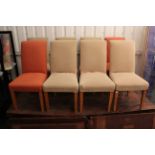 A set of eight dining chairs with padded seats & backs, & on square tapered legs.