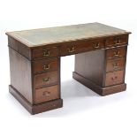 A Victorian mahogany pedestal desk inset tooled green leather cloth, fitted with an arrangement of