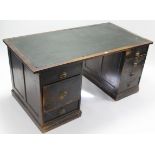 An early 20th century black painted oak knee-hole office desk inset green leatherette to the