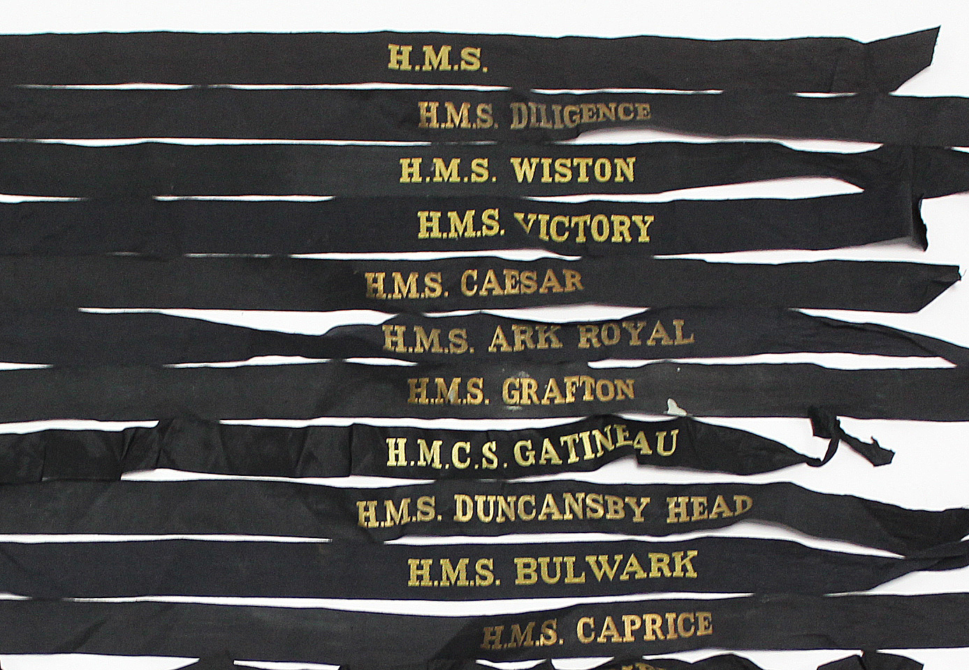 Approximately thirty various Royal Navy cap tallies.