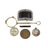 A pair of gilt-metal lorgnettes; an enamelled “Women’s Suffrage” badge; a paste-set shoe buckle,