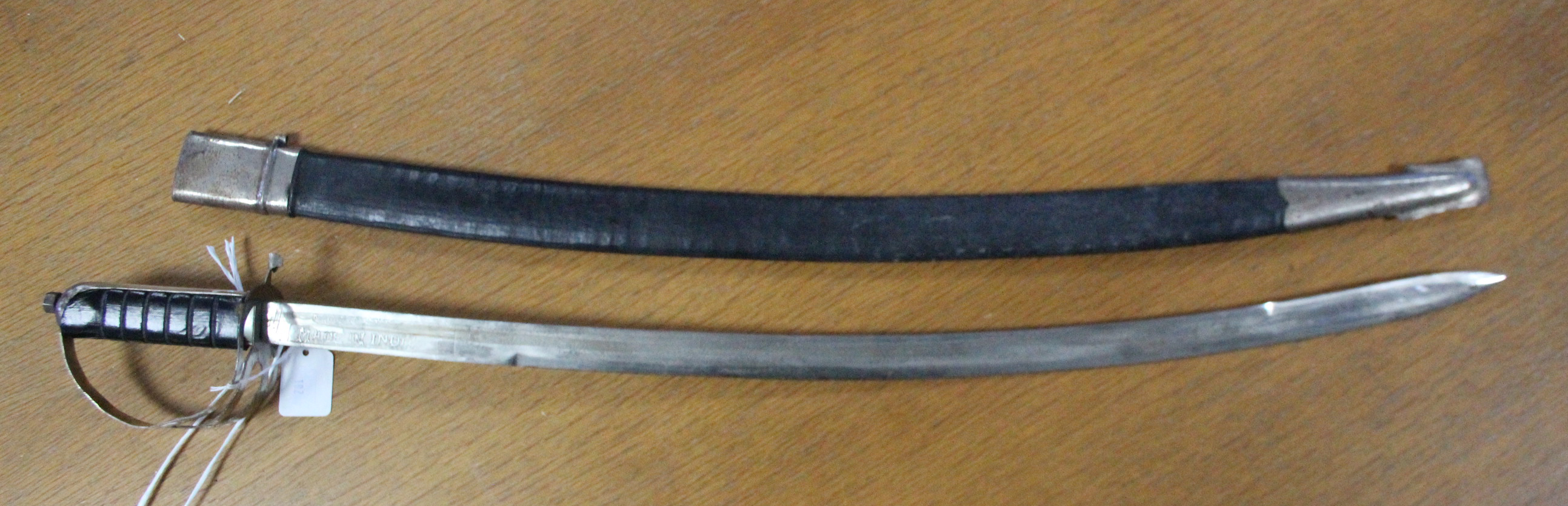 An Indian Cavalry Officer’s dress sword with 29” long single-edge curved blade, complete with