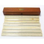 Seven ivory rulers in a fitted mahogany box, 13½” long.