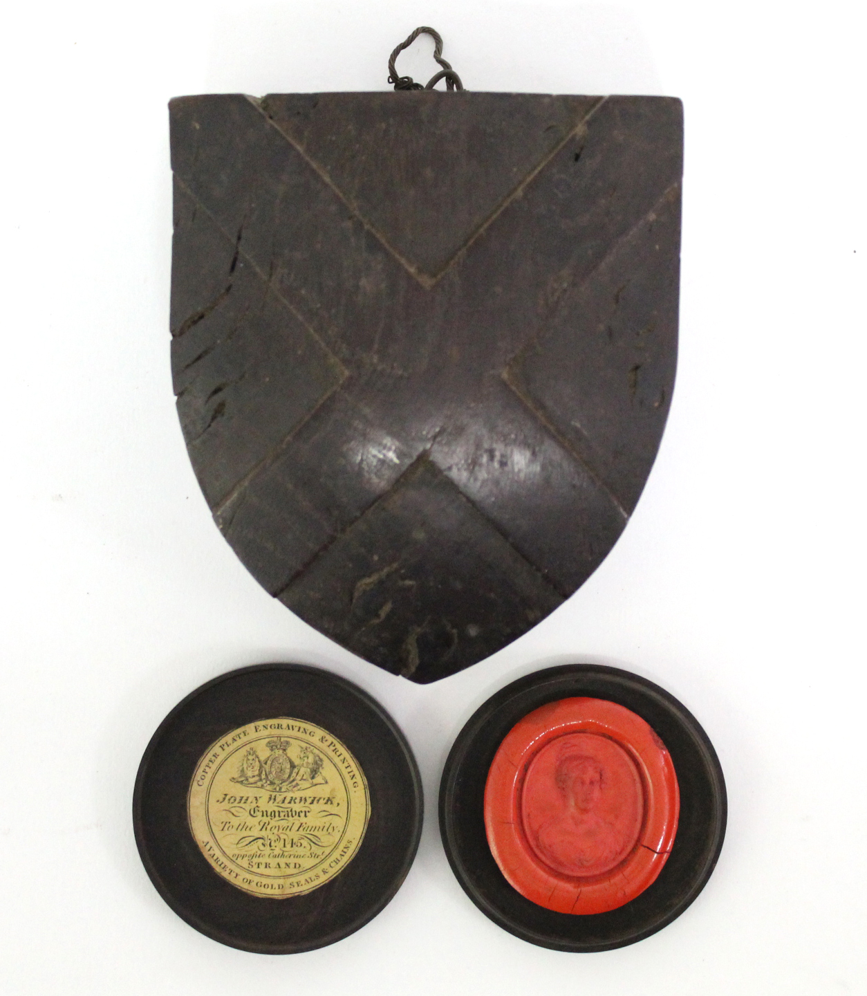 An early 19th century turned wood flat circular seal box, bearing paper trade label of “John Warwick