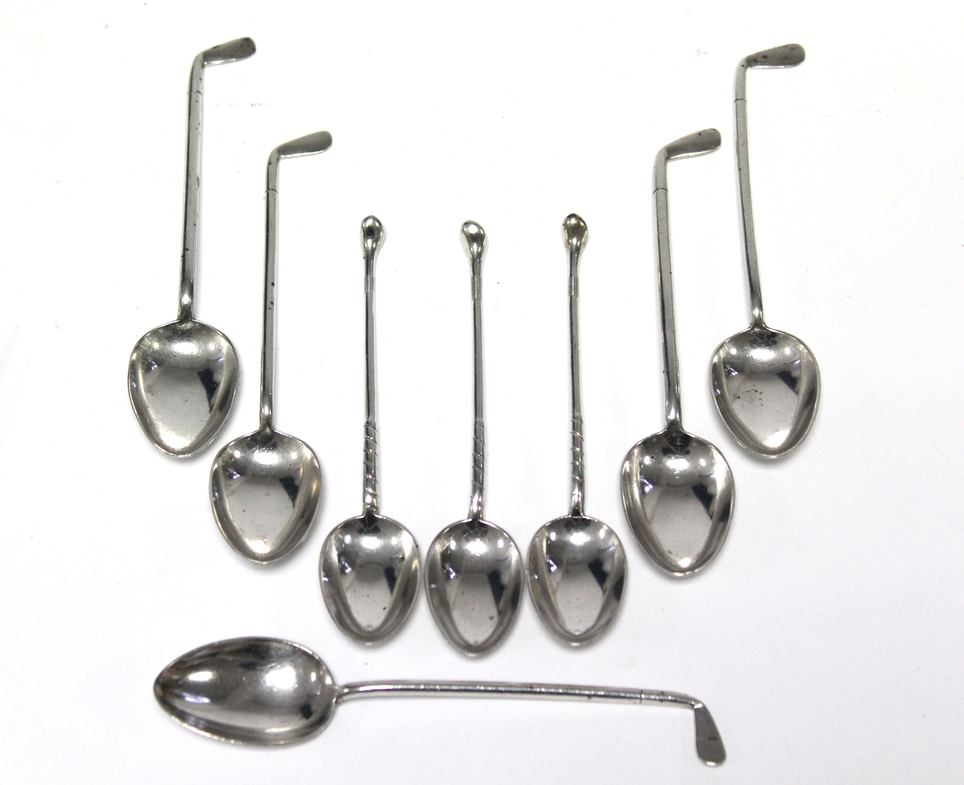 Eight various silver novelty teaspoons, each with golf club stems.