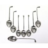 Eight various silver novelty teaspoons, each with golf club stems.