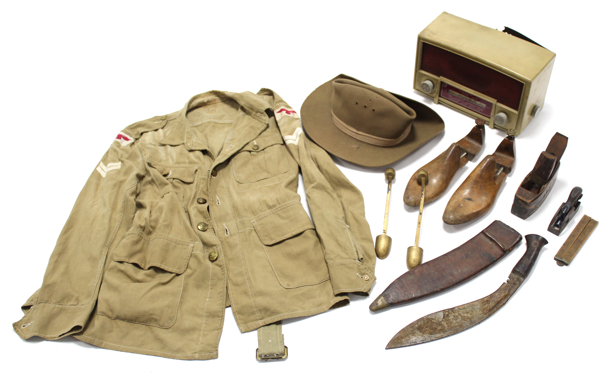 A WWII British soldier’s hat; a Kukri; two carpenters planes; a Cossor valve radio; two pairs of