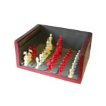 An early 20th century carved bone chess set of natural & red stain, size of Kings 4½” high (