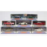 Eight Dinky scale model cars, each with window box.