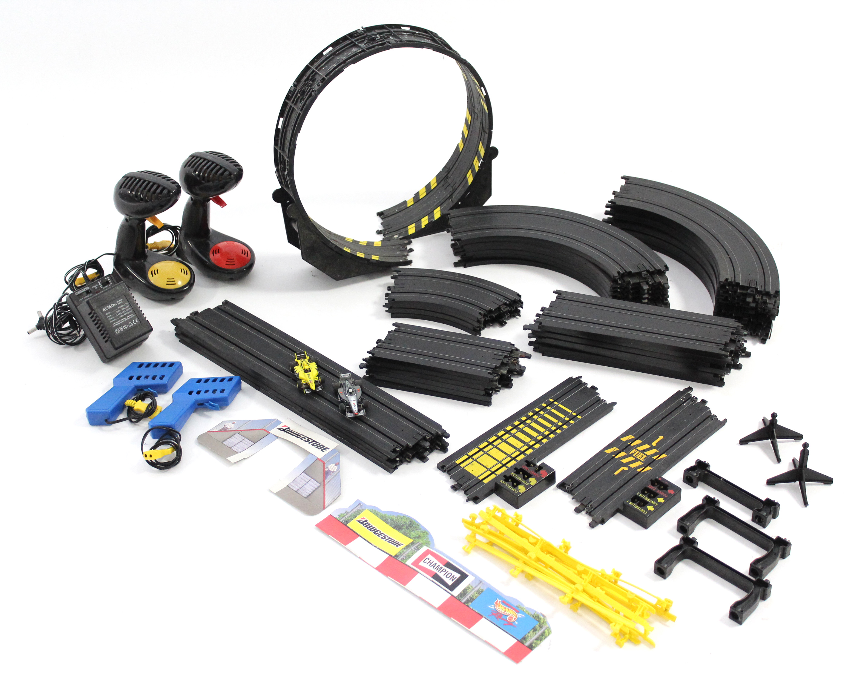 A Quantity of Scalextric track complete with two cars & two pairs of controllers.