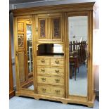 A LATE VICTORIAN ASH COMBINATION WARDROBE with cupboard to centre enclosed by carved panel door