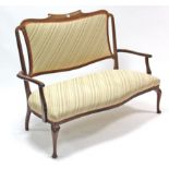An Edwardian beech-frame two-seater salon settee with padded back & sprung seat upholstered multi-