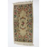 A modern Chinese rug of cream & pale blue ground & with all-over repeating multi-coloured floral