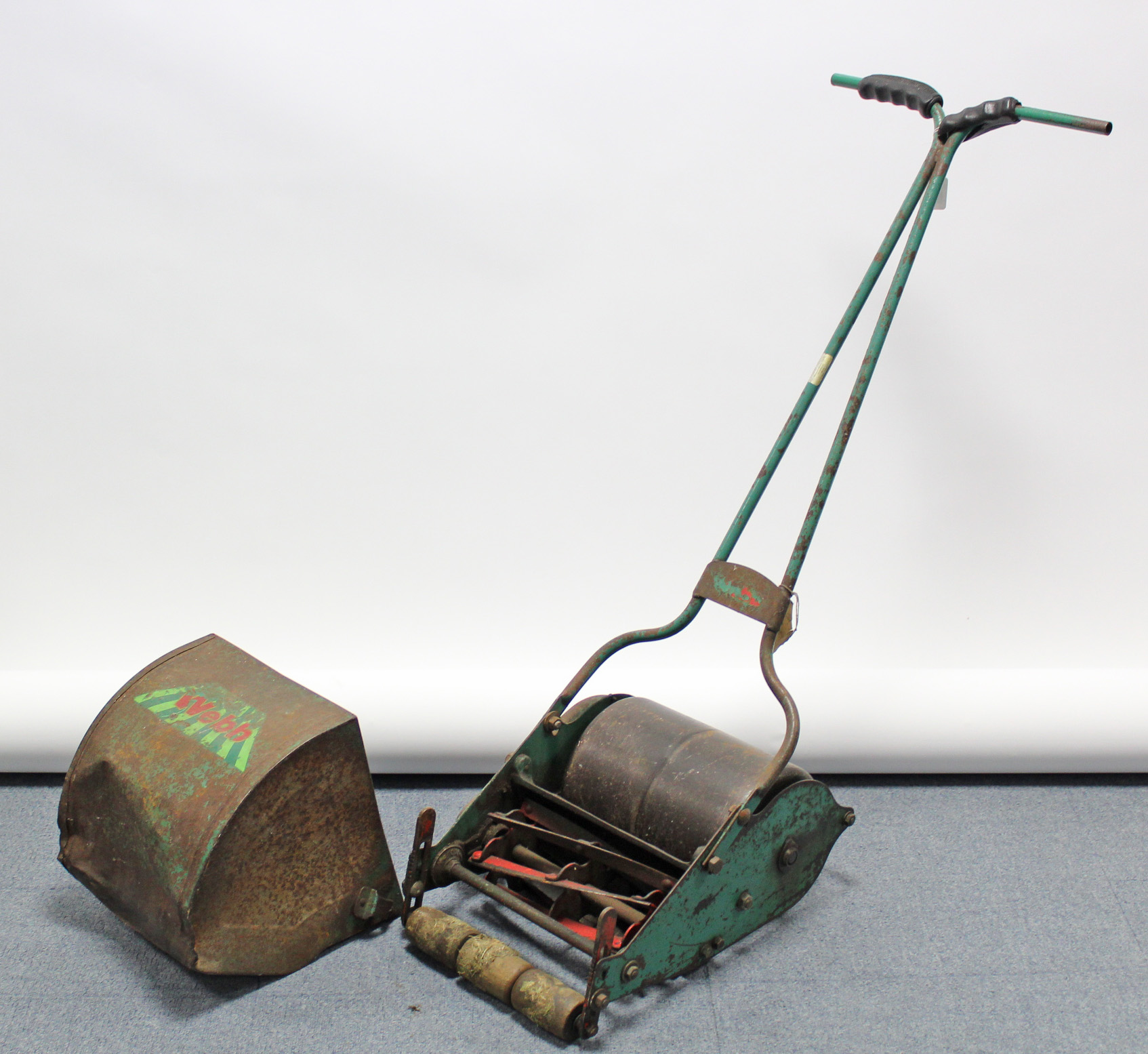 A vintage Webb push-along lawn mower with grass box.