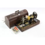 A Singer hand sewing machine with oak case.