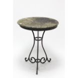 A black finish wrought-iron garden table on three shaped supports & with weathered marble top,