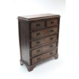 A hardwood chest, fitted two short & four long drawers with brass swing handles, & on bracket