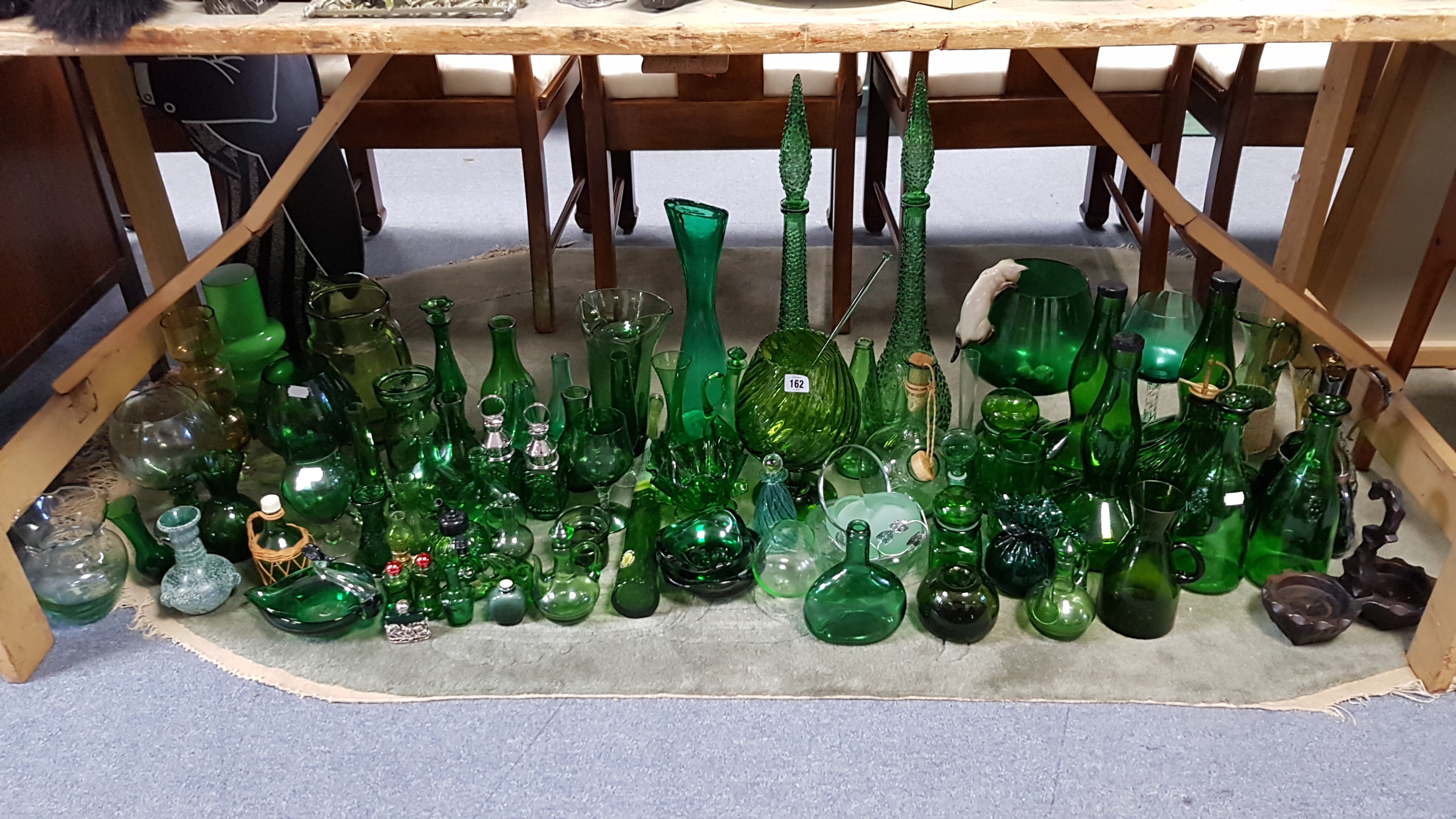 A large collection of green tinted glassware.