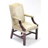 A Georgian-style mahogany-frame easy chair, the padded back, arms & sprung seat upholstered brass
