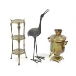 A large bronzed ornament in the form of a standing crane, 36” high; a brass tea urn (lacking cover);