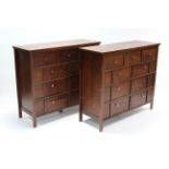 A pair of mahogany-finish chests, each fitted with an arrangement of nine drawers, 44 ¼” wide x