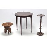 An Eastern carved hardwood occasional table with circular top & on three shaped & pierced legs,