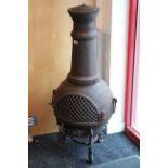 A cast-iron chimenea, 43” high.