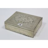 An Alpaca (Argentina) silvered-metal trinket box with embossed design, 9½” wide.