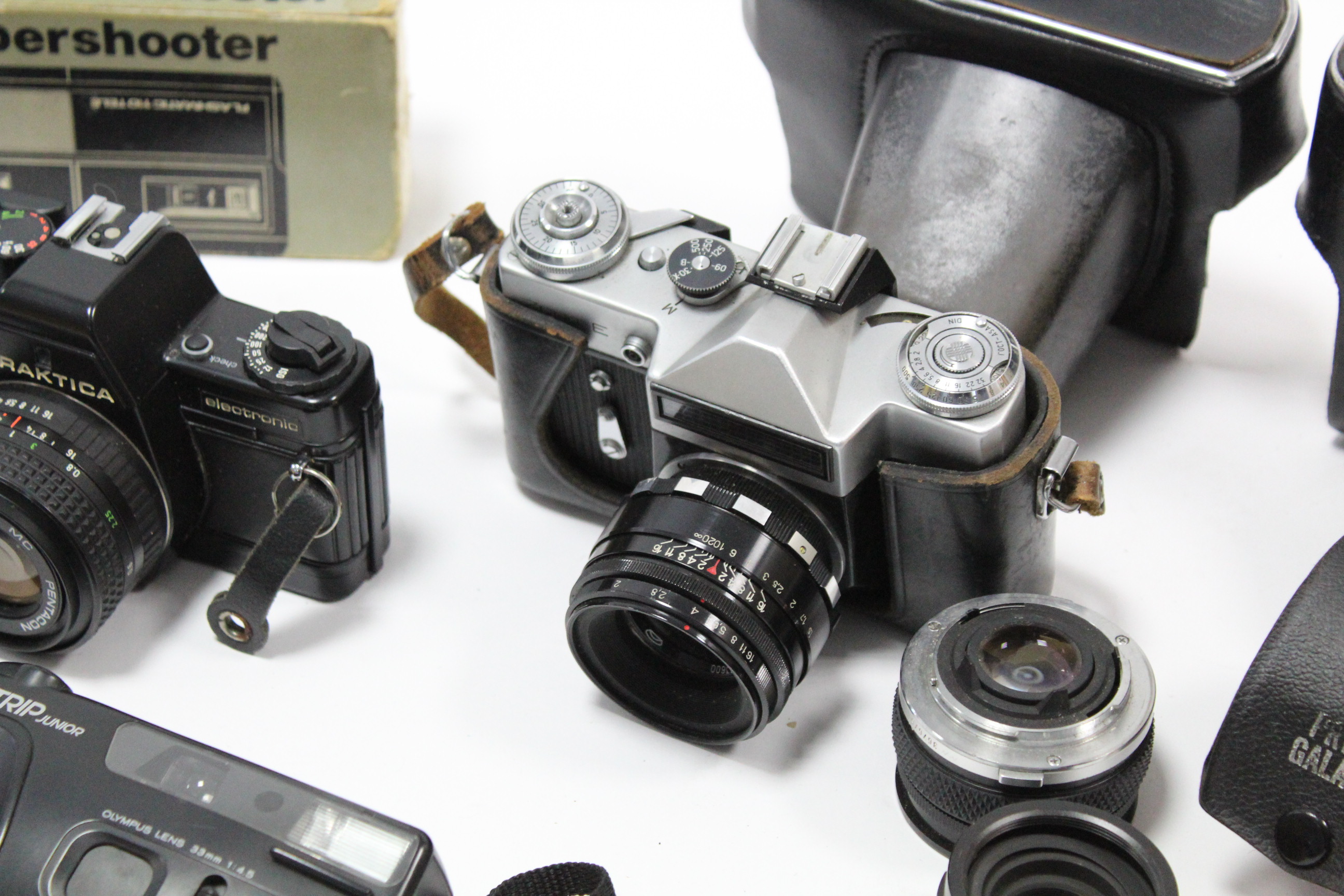 A Zenit TTL camera; a Zenit-E camera; a Praktica BMS camera; two other cameras; & various camera