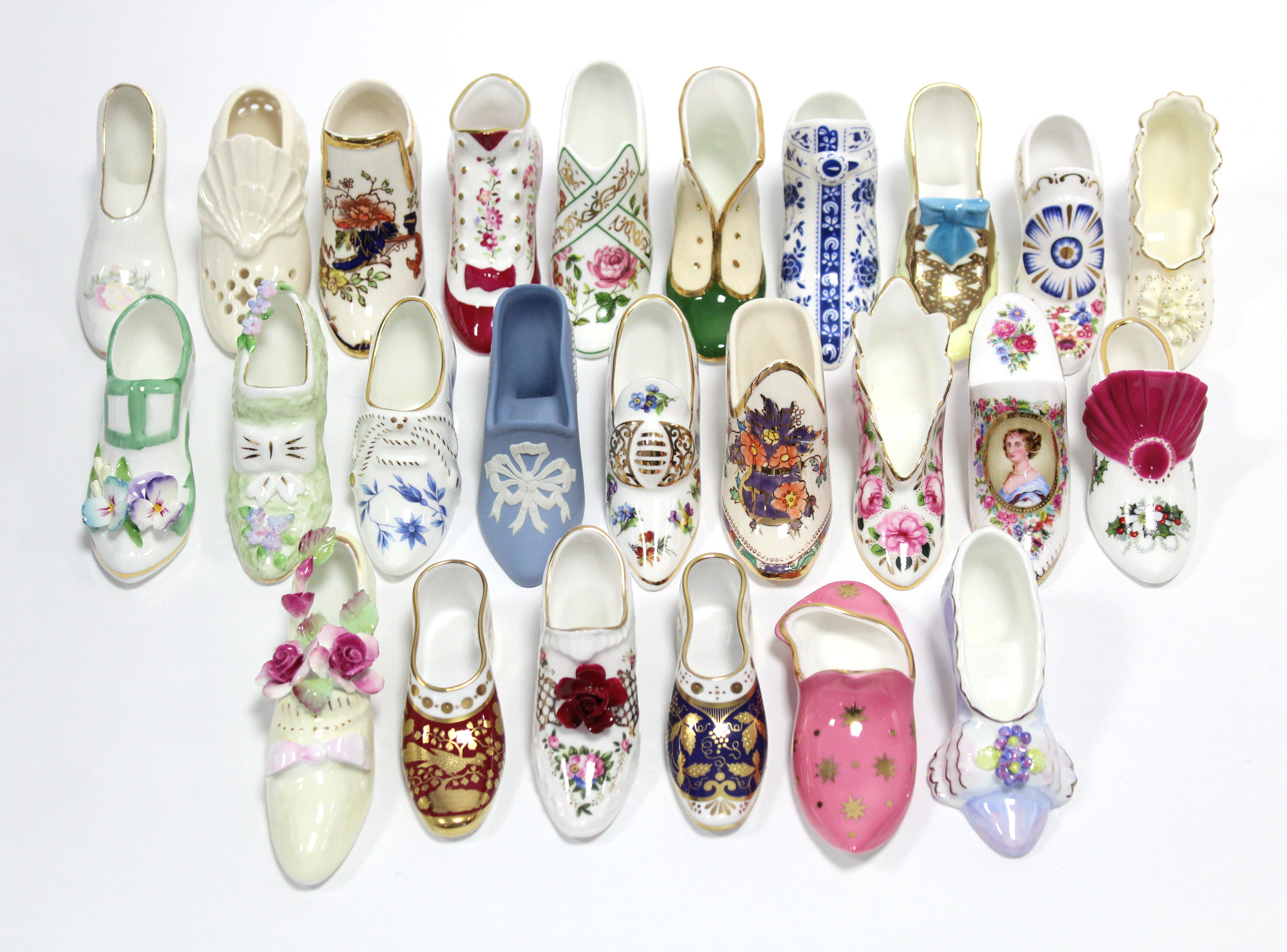 A collection of approximately thirty various bone china shoe ornaments.