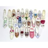 A collection of approximately thirty various bone china shoe ornaments.