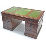 A reproduction mahogany large pedestal desk inset gilt-tooled green leather, fitted with an