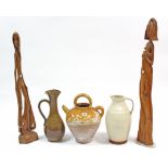 A stoneware Gascon confit kettle; two pottery ewers; & two large carved wooden figures.