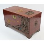A Chinese camphor wood chest with carved figure scene decoration to the hinged lift-lid, front, &