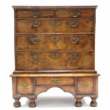 AN EARLY 18th century FIGURED WALNUT CHEST-ON-STAND, with moulded cornice, fitted two short &