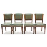 A set of four late Victorian dining chairs with padded leather seats & backs, on turned tapering