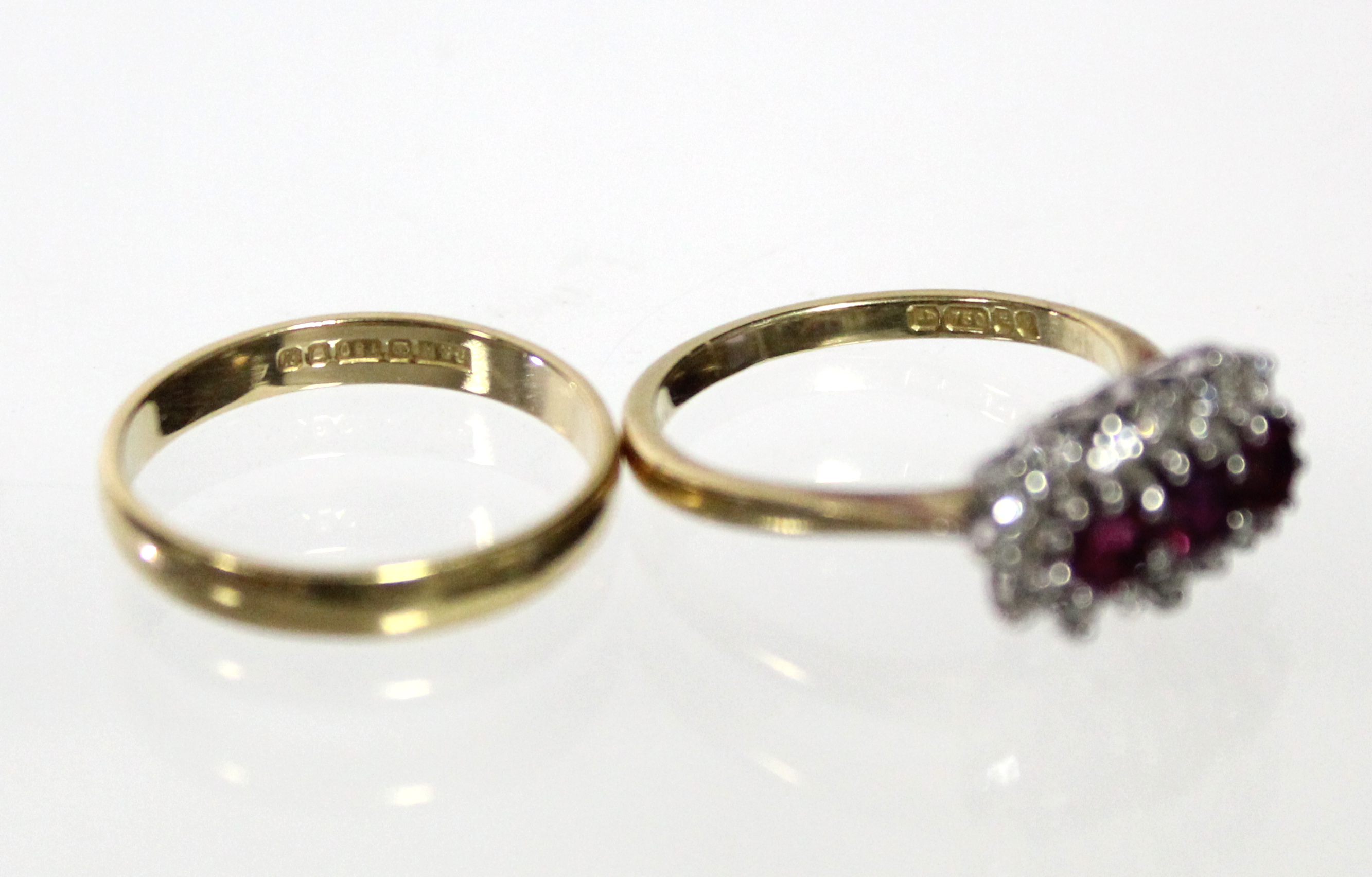 An 18ct. gold ring set three rubies within a border of small diamonds (Size: M); & an 18ct. gold - Image 4 of 5