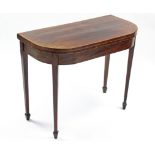 An early 19th century mahogany card table, the rectangular top with rosewood crossbanding &
